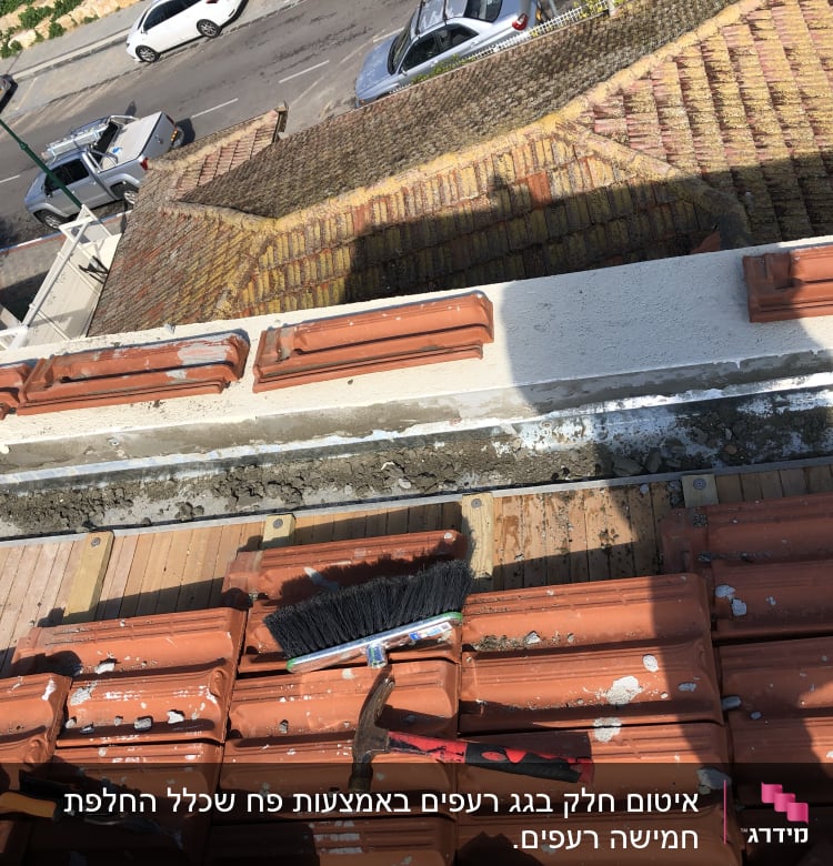 כלי עבודה על גג רעפים עם מברשת ופטיש